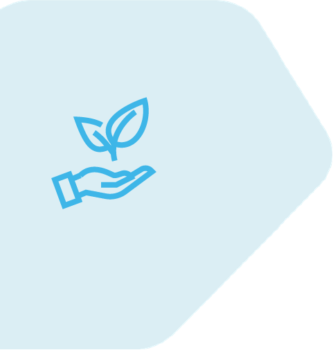 Two co-workers look at a laptop and smile